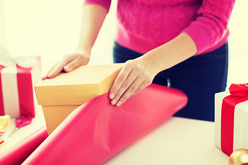 Image showing close up of woman decorating christmas presents