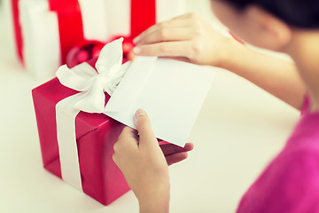 Image showing close up of woman with letter and presents