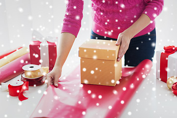 Image showing close up of woman decorating christmas presents