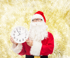 Image showing man in costume of santa claus with clock