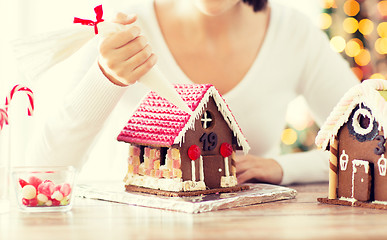 Image showing close up of woman making gingerbread houses