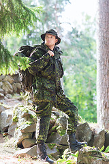 Image showing young soldier with backpack in forest