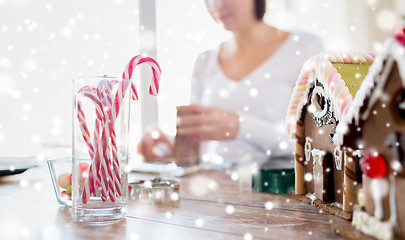 Image showing close up of woman making gingerbread houses