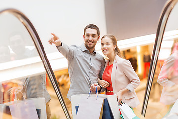 Image showing happy young couple with shopping bags in mall