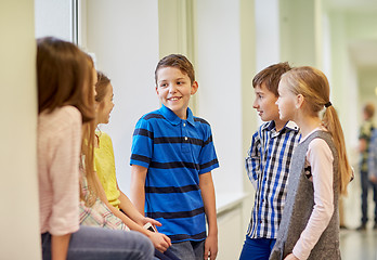 Image showing group of smiling school kids talking in corridor