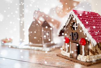 Image showing close up of woman making gingerbread houses