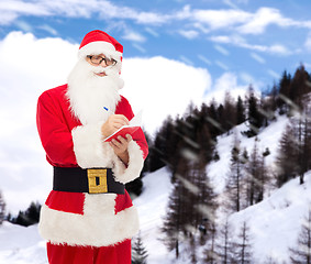 Image showing man in costume of santa claus with notepad