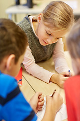 Image showing group of students talking and writing at school