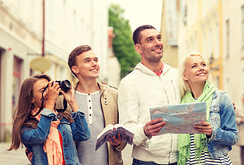 Image showing group of friends with city guide, map and camera