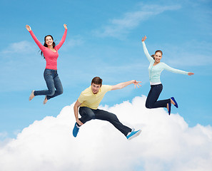 Image showing group of smiling teenagers jumping in air