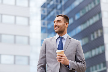 Image showing young smiling businessman with paper cup outdoors