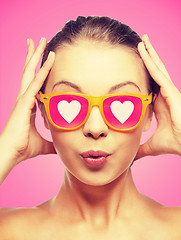 Image showing surprised teenage girl in pink sunglasses