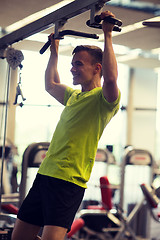 Image showing smiling man exercising in gym