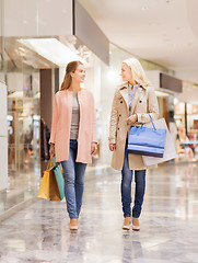 Image showing happy young women with shopping bags in mall