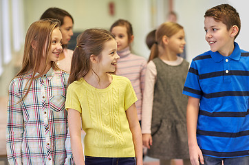 Image showing group of smiling school kids walking in corridor