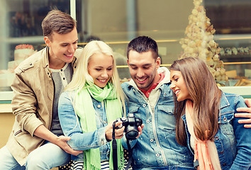 Image showing group of smiling friends with digital photocamera