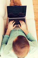 Image showing close up of man working with laptop at home