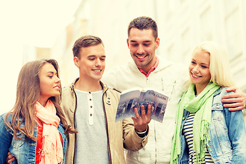 Image showing group of friends with city guide exploring town