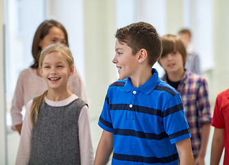 Image showing group of smiling school kids walking in corridor