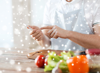 Image showing close up of man reading recipe from smartphone