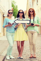 Image showing smiling teenage girls with white arrow outdoors