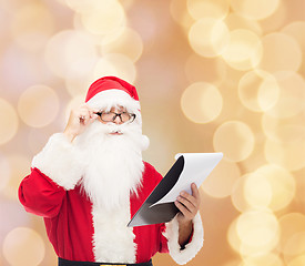 Image showing man in costume of santa claus with notepad