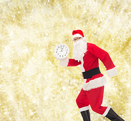 Image showing man in costume of santa claus with clock