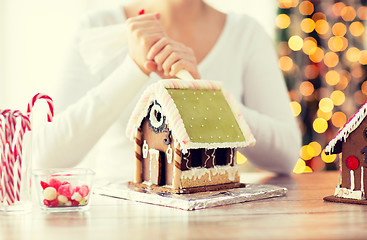 Image showing close up of woman making gingerbread houses