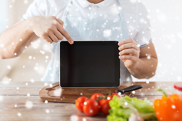 Image showing closeup of man showing tablet pc screen in kitchen