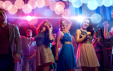 Image showing smiling friends dancing in club