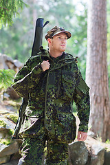 Image showing young soldier or hunter with gun in forest