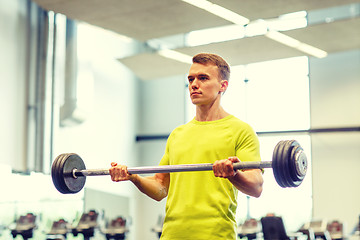 Image showing man doing exercise with barbell in gym