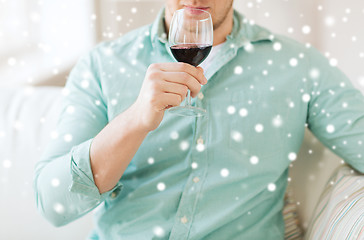 Image showing close up of man drinking red wine at home