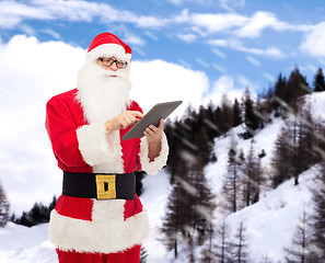 Image showing man in costume of santa claus with tablet pc