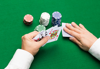 Image showing poker player with cards and chips at casino