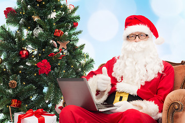 Image showing man in costume of santa claus with laptop