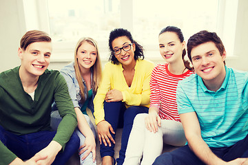 Image showing five smiling teenagers having fun at home