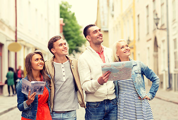 Image showing group of smiling friends with city guide and map