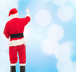 Image showing man in costume of santa claus writing something