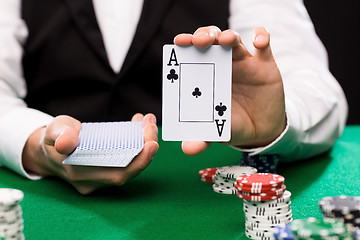 Image showing holdem dealer with playing cards and casino chips