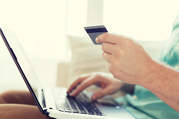 Image showing close up of man with laptop and credit card