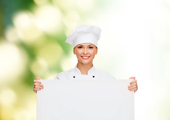 Image showing smiling female chef with white blank board