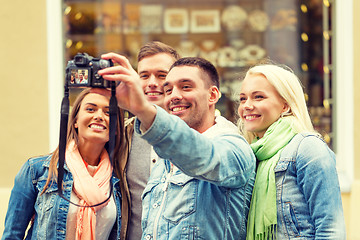 Image showing group of smiling friends making selfie outdoors