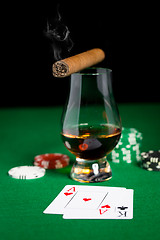 Image showing close up of chips, cards whisky and cigar on table