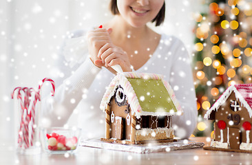 Image showing close up of woman making gingerbread houses