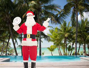 Image showing man in costume of santa claus with clock