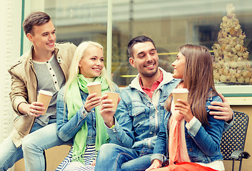 Image showing group of smiling friends with take away coffee