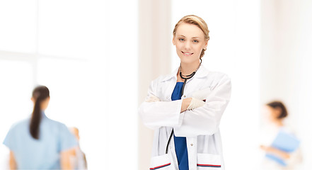 Image showing smiling young female doctor in white coat