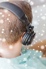 Image showing close up of man in headphones at home