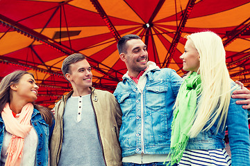 Image showing group of smiling friends in amusement park